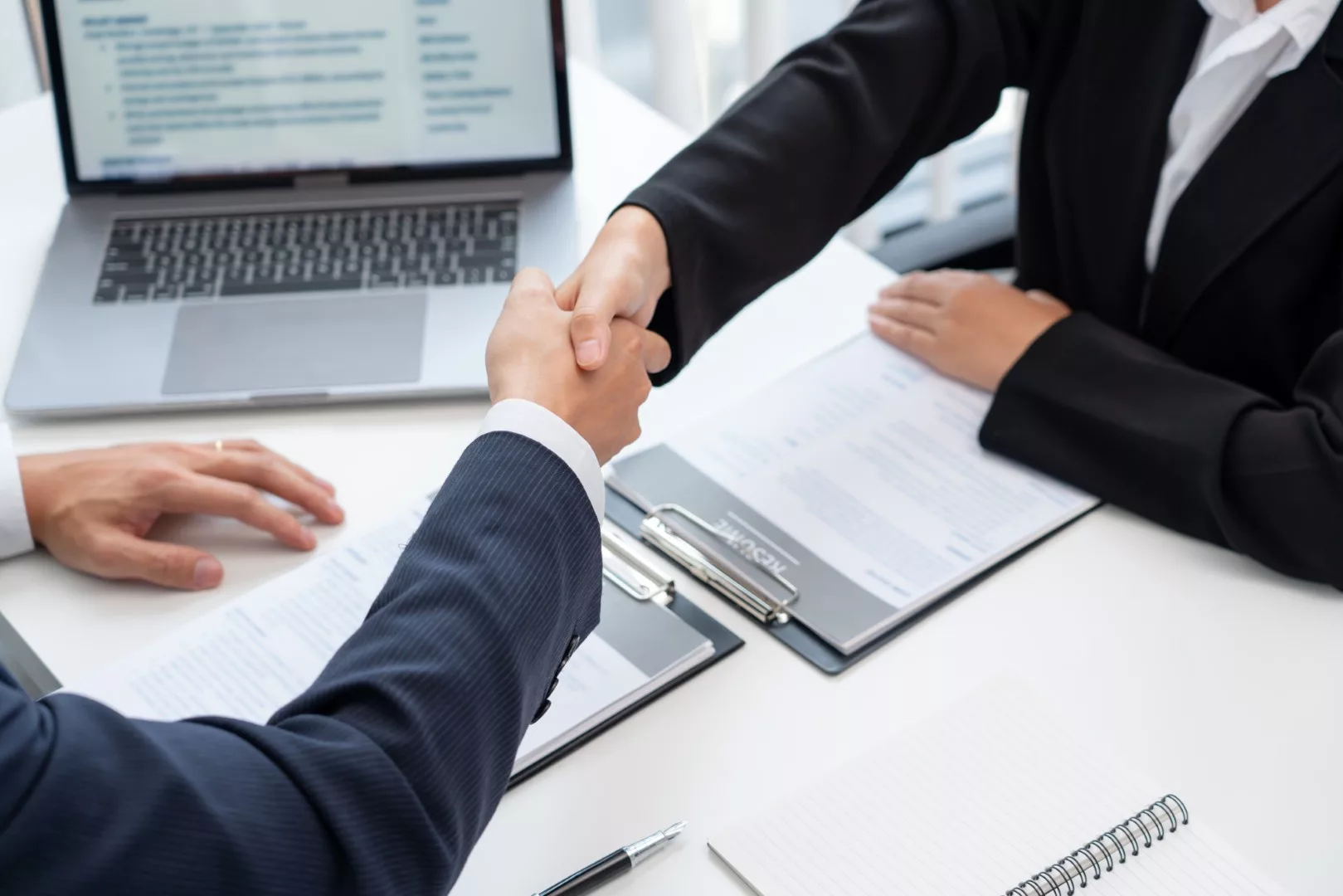 two business people shaking hands of Candidate asian businesswom